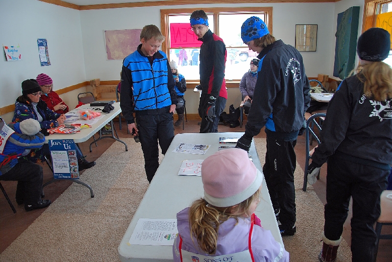 Workers and race fore runners look over the various course routes prior to the beginning in the Hancock Ski Chalet at the Hancock Fairgrounds.