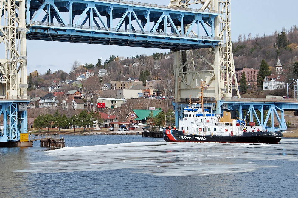 Our Bridge photo for this year, is of the Coast Guard Cutter Katmai Bay, which on May 6th, came through the Waterway to break the heavy ice that formed this past winter. Ice was still floating in Lake Superior a month later.