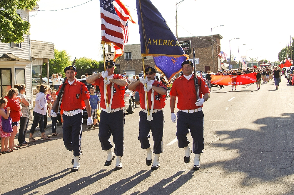 The Alfred Erickson Post 186, American Legion, of Hancock, leads off this year�s Friday evening Parade in beautiful weather.