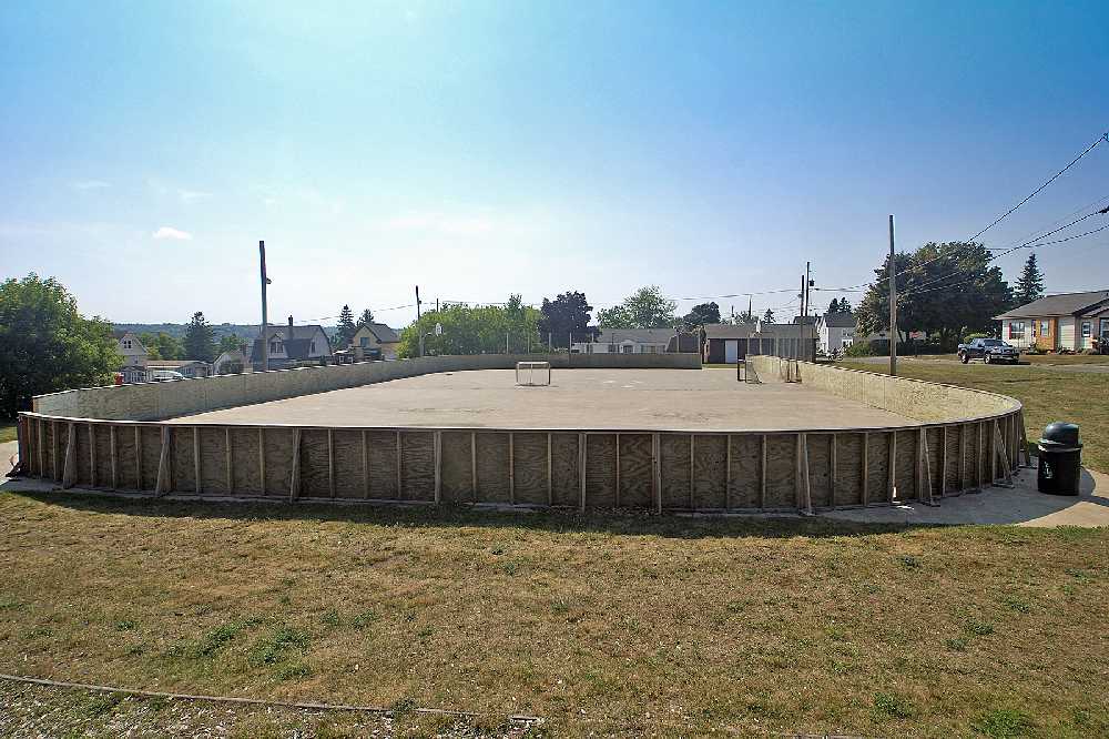 A view of the ice rink, with recently replaced side boards, the warming hut is at the right rear.