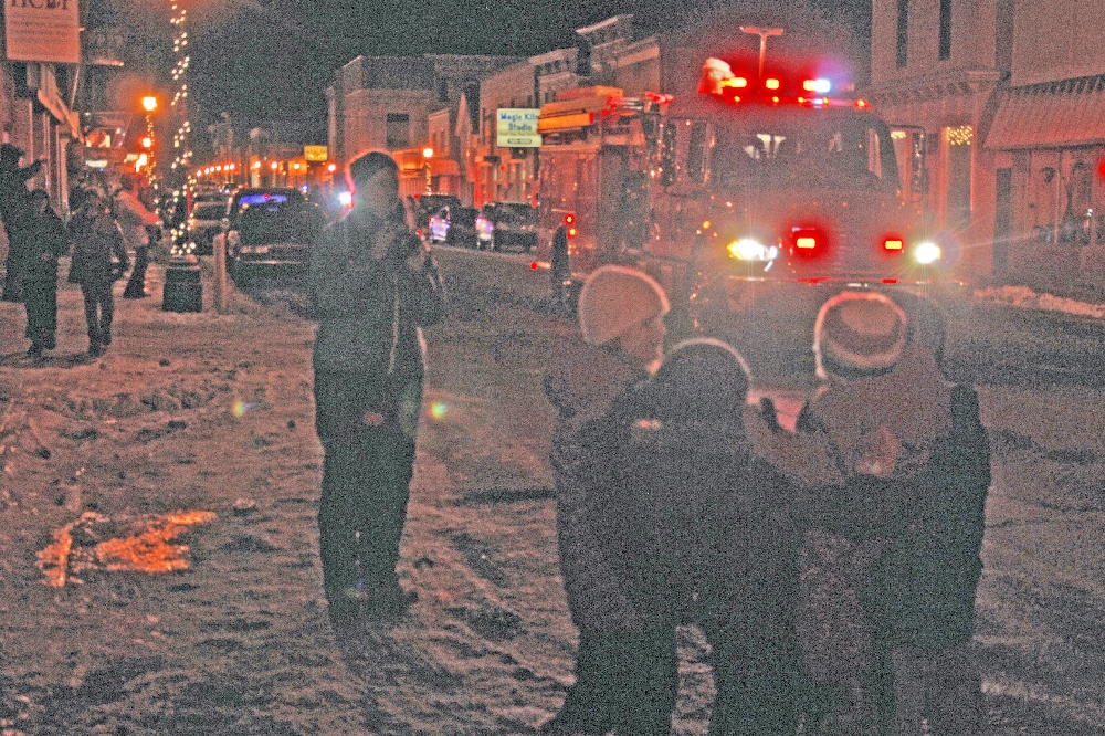 Santa Claus and the Truck reach City Hall, with a large number of youngsters and their parents already waiting to greet and talk with him.