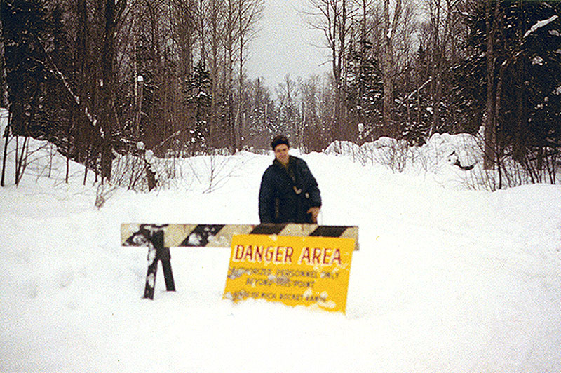 These pictures were made by Roland Burgan, General Manager/News Director for WHDF (now WCCY), over two trips made over two consecutive days, Thursday, Jan. 28th, and Friday, Jan. 29th, 1971. Accompanying was a brother, Read Burgan, then Gen. Mgr. of WGGL-FM (PBS station at MTU). Here, Read Burgan, at road warning sign 2 miles E. Of Copper Harbor.