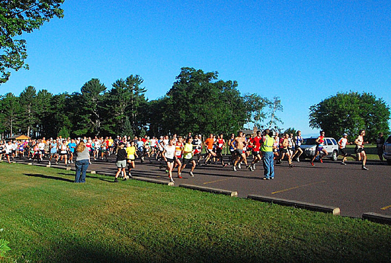 The Canal Run portion kicked off early Saturday morning with the start of the 10 mile Walk & Run at McLains State Park, on Lake Superior. Here, the Run start. Note WLUC-TV6 Sports Director Mike Ludlum (yellow vest w/camera ( R )), making a �death defying � video from head-on. (Mike somehow survived, as did those who crashed into him, apparently). There were 667 persons signed up this year.