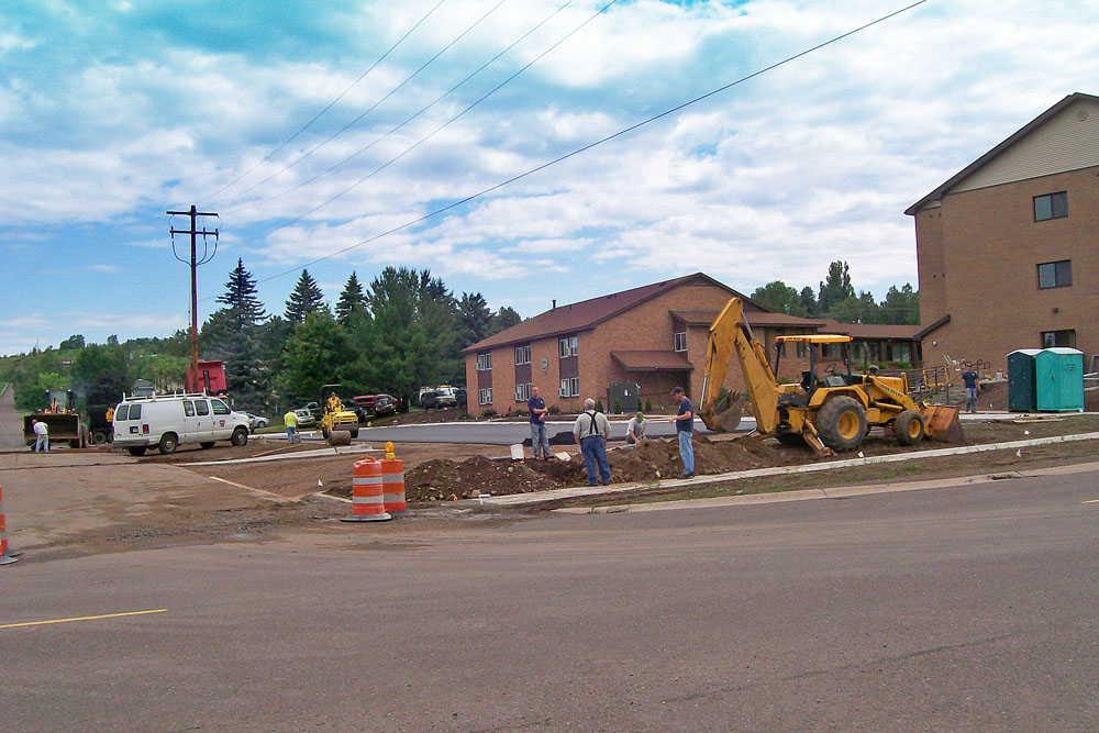 Mid July saw outside construction pretty well completed, as paving crews paved the new parking lot. Sidewalks and most other landscaping have also been completed.