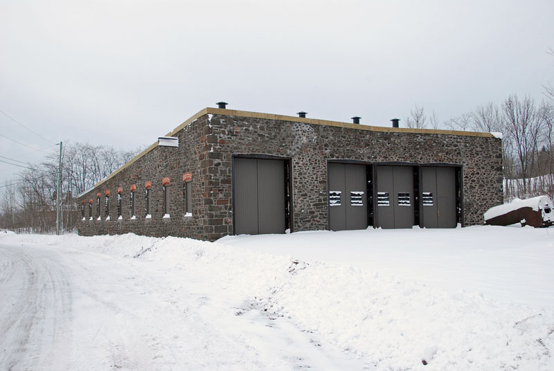 By the end of November, winter has arrived, ending outside work.  But the windows are enclosed, the new doors are on, and the structure is enclosed.