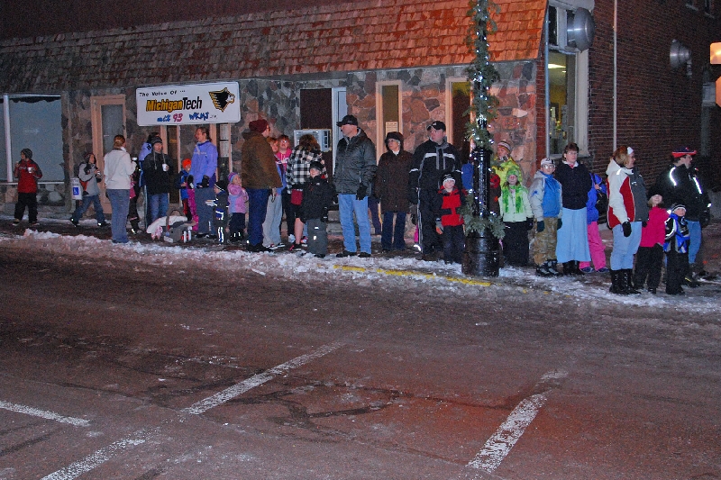 A good crowd is on hand in front of WMPL, to hear outside Christmas music and await the next run of the horse drawn sleigh ride through town.